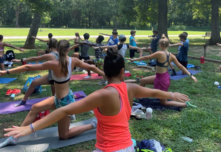 Kids at FMXC Summer Camp stretching and doing yoga before a run